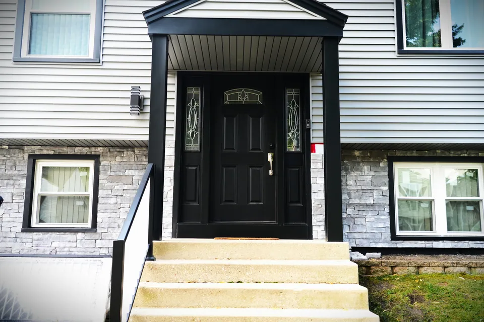 A new black fiberglass entry door with sidelites on a Chicagoland south-suburb home — an Excel install